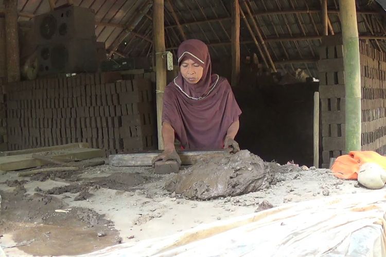 Haeriah (51), ibu empat anak di Kabupaten Gowa, Provinsi Sulawesi Selatan, tengah membuat batu bata untuk bertahan hidup dari kemiskinan yang dialaminya. Jumat (2/2/2018).