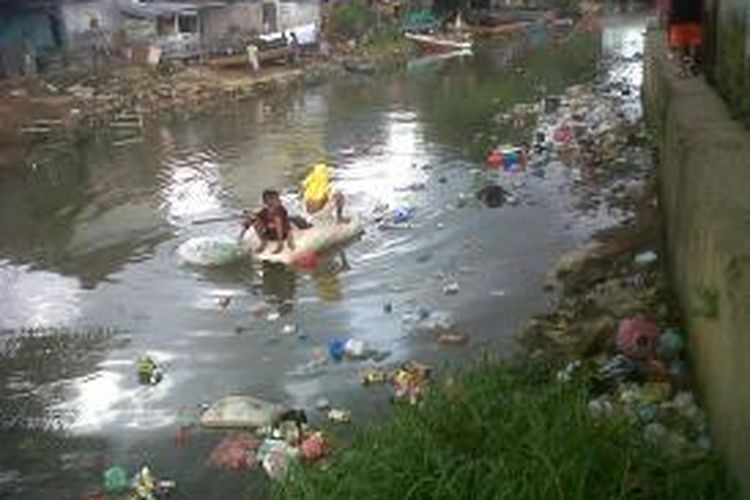 Kondisi sungai Wai Batu Merah yang dipenuhi sampah, tampak sejumlah anak tengah bermain di sungai yang kotor itu, Rabu (19/3/2014).
