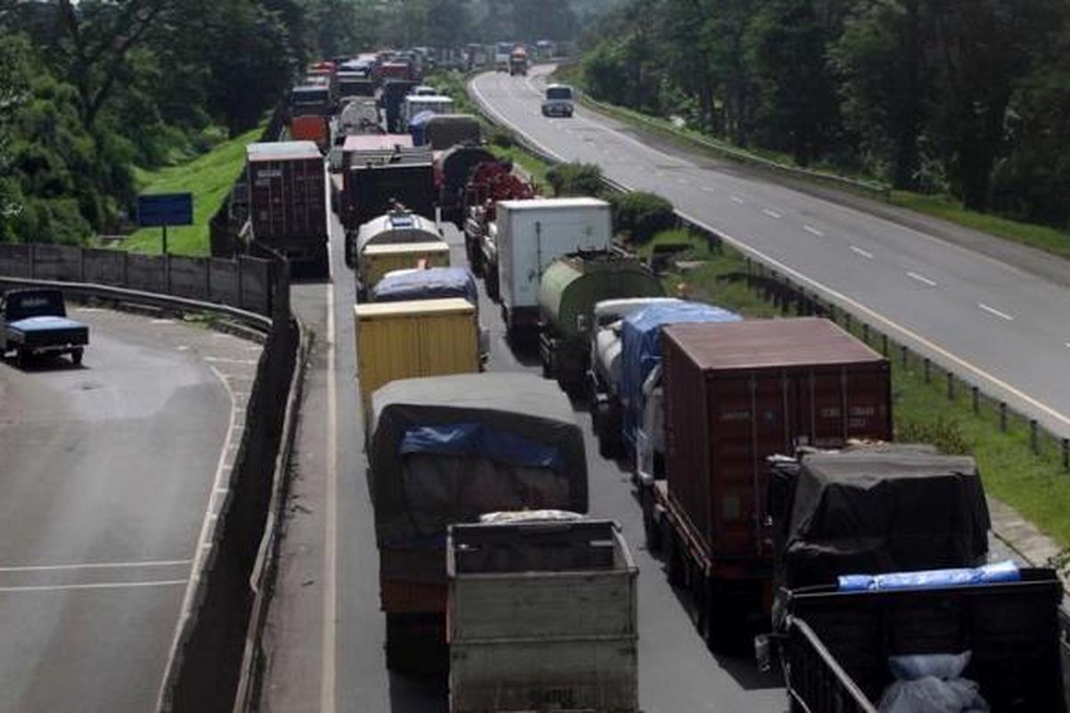 Mobil terjebak macet tol Jakarta-Merak di Balaraja Timur, Serang, Banten, akibat banjir luapan Sungai Ciujung yang merendam tol di kilometer 57, Kamis (10/1/2013). Akibat banjir ini akses tol Jakarta-Merak putus dan ratusan rumah warga terendam. KOMPAS IMAGES/KRISTIANTO PURNOMO