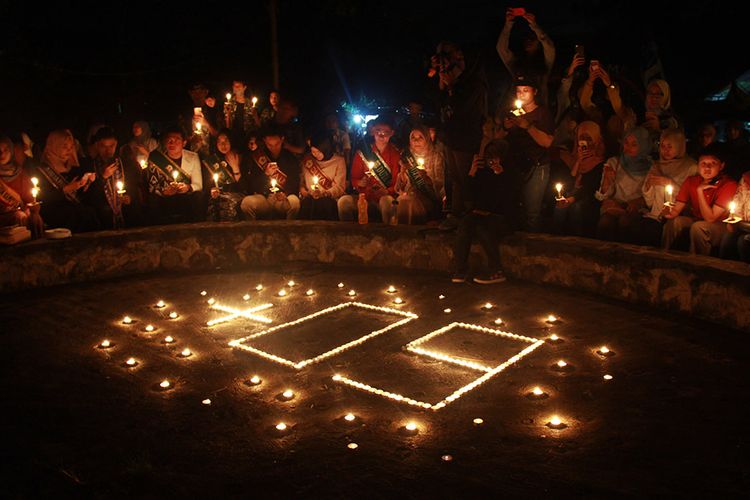Sejumlah aktivis pecinta lingkungan menyalakan lilin saat Peringatan Earth Hour di Serang, Banten, Sabtu (30/3/2019) malam. Peringatan itu berlangsung khidmat dengan mematikan lampu selama 60 menit untuk mengurangi laju pemanasan global.