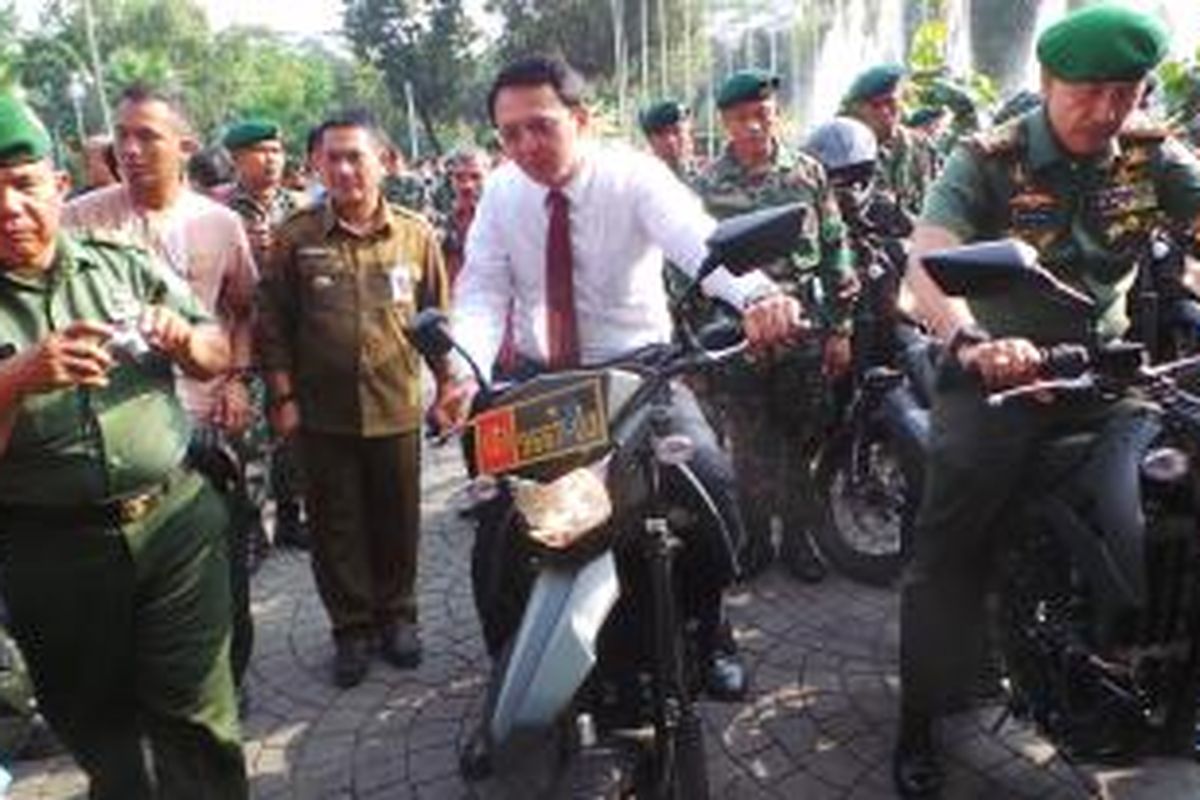 Gubernur DKI Jakarta Basuki Tjahaja Purnama menaiki motor Kawasaki Kawasaki D-Tracker 250 CC yang dihibahkan DKI kepada Kodam Jaya, di Balai Kota, Jumat (7/8/2015). 