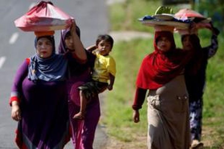 Para ibu-ibu membawa hantaran makanan untuk prosesi Mendoa di Jalan Raya Payahkumbuh-Lintau, Sumatera Barat, Senin (8/7/2013). Hantaran makanan ini dibawa dan dimasak para ibu-ibu untuk acara Mendoa (berdoa bersama dan siraman rohani) di masjid terdekat mereka dalam menyambut Bulan Puasa.