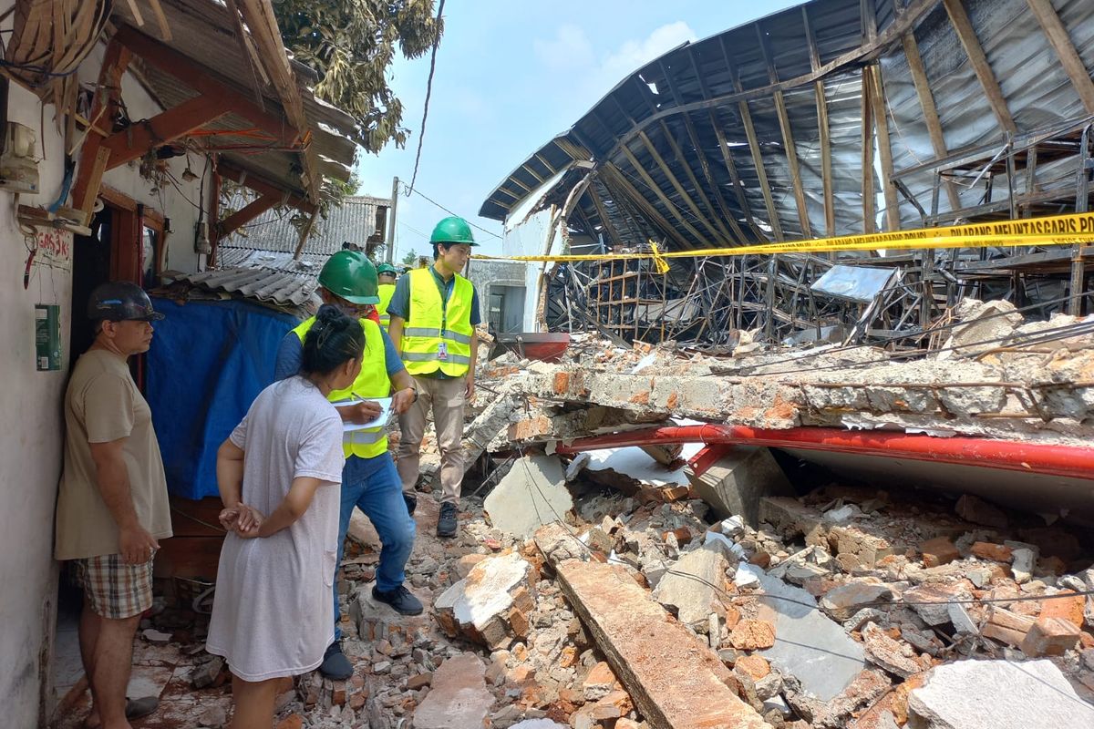 Saat beberapa orang dari pihak JNE Express tengah mendata rumah-rumah warga yang rusak akibat terdampak kebakaran Gudang JNE di Jalan Pekapuran, Curug, Cimanggis, Depok. 