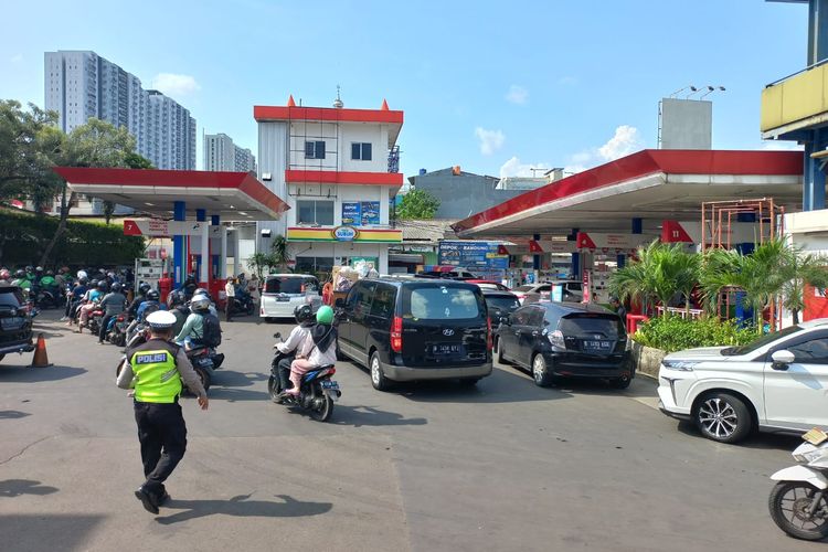 Situasi antrean panjang di SPBU di Jalan Raya Margonda, Depok pada Sabtu (3/9/2022). Tampak dua personel kepolisian lalu lintas tengah mengatur antrean itu menjelang diberlakukannya harga BBM terbaru.