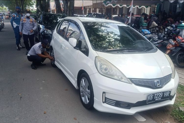 Sejumlah mobil yang parkir di pinggir Jalan Alianyang, Kota Pontianak, Kalimantan Barat (Kalbar) dikempeskan petugas. Kepala Dinas Perhubungan Kota Pontianak Utin Srilena Chandramidi mengatakan, tindakan tersebut dilakukan karena pemilik kendaraan melanggar aturan terkait parkir, sehingga memicu kemacetan serta rawan terjadinya kecelakaan. 