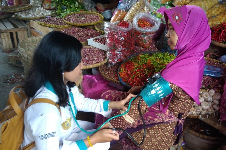 Seorang Siswi SMK Giri Handayani sedang memeriksa tekanan darah salah seorang pedagang Pasar Playen, Gunungkidul, Yogyakarta, Senin (13/5/2019). 