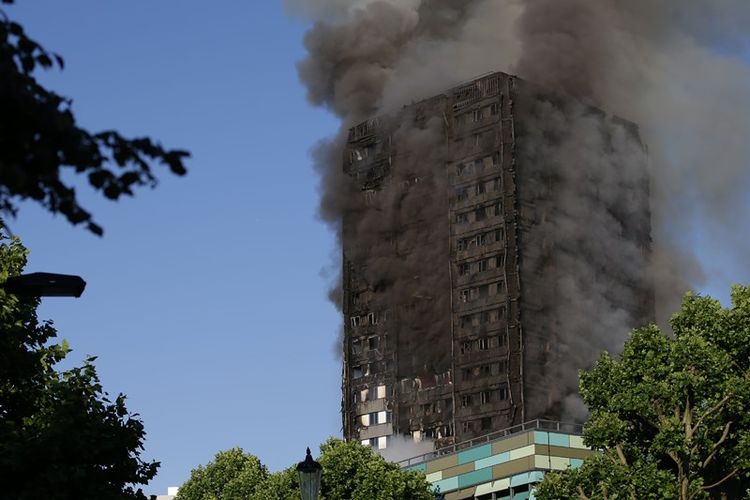 Asap mengepul dari gedung apartemen Menara Grenfell, London, yang terbakar pada Rabu (14/6/2017).