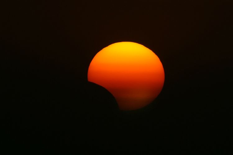 Foto fenomena gerhana matahari hibrida pada 3 November 2013 yang diambil di Arbil, Irak. Saat itu, gerhana matahari hibrid juga dapat dilihat antara lain di Afrika, Eropa, dan Amerika Serikat, dengan sebagian melihat gerhana matahari total dan sebagian yang lain melihat gerhana matahari parsial, tergantung lokasi dan posisi bulan yang menutupi matahari. 