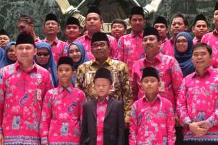 Pelaksana Tugas (Plt) Gubernur DKI Jakarta Sumarsono (batik kuning) seusai memberikan bonus kepada peserta MTQ dan STQ, di Balai Kota DKI Jakarta, Jumat (23/12/2016).