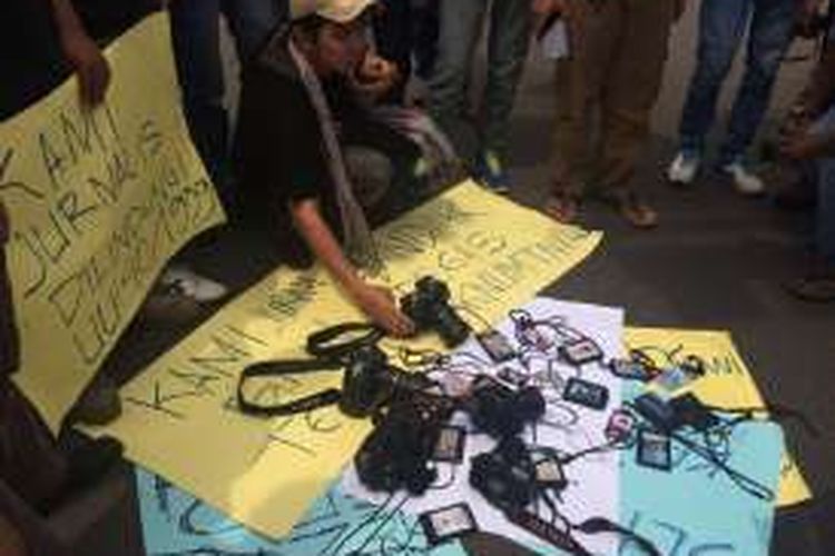 Sejumlah wartawan meletakkan id pers dan kamera sebagai simbol penolakkan kekerasan terhadap wartawan, di Tugu Kujang, Kota Bogor, Selasa (16/8/2016). Puluhan wartawan baik dari media cetak, tv, dan elektronik melakukan aksi unjuk rasa sebagai bentuk dukungan terhadap kasus kekerasan yang menimpa sejumlah wartawan di Sari Rejo, Medan.