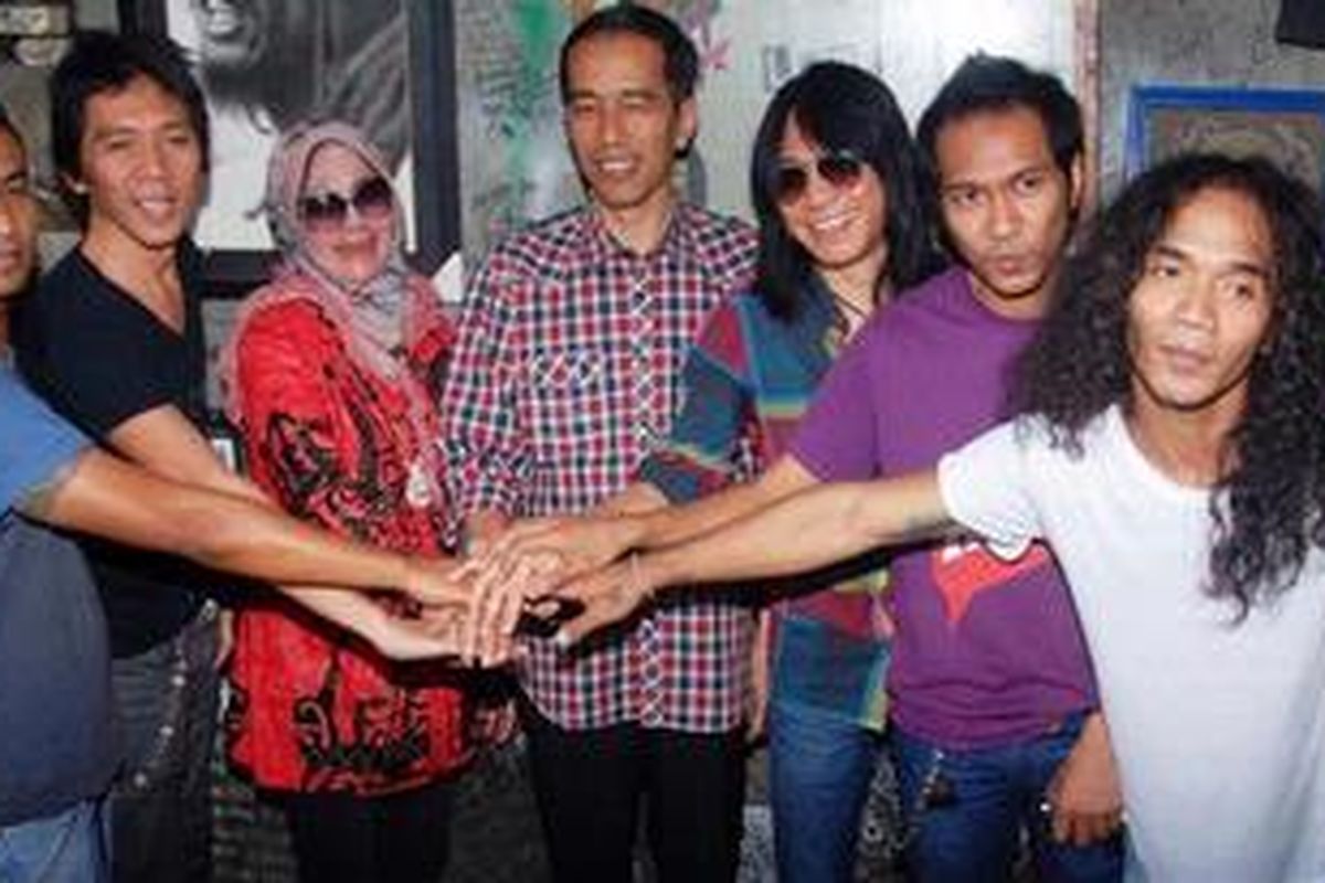 Bakal calon gubernur DKI Jakarta, Joko Widodo atau biasa disapa Jokowi (kemeja kotak-kotak) berfoto bersama para personel Slank saat mendatangi markas Slank di Jalan Potlot, Duren Tiga, Jakarta Selatan, Senin (16/4/2012). Kepada wartawan Jokowi mengatakan kunjungannya ke markas Slank bukan mencari dukungan tetapi hanya silaturahim.