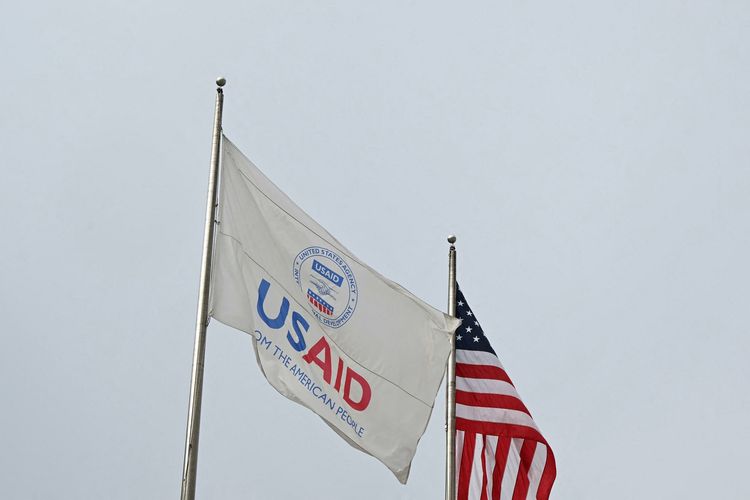 Bendera USAID dan Amerika Serikat berkibar sebelum Kongres Demokrat digelar di luar markas besar Unites States Agency for International Development (USAID) di Washington DC, Senin (3/2/2025).