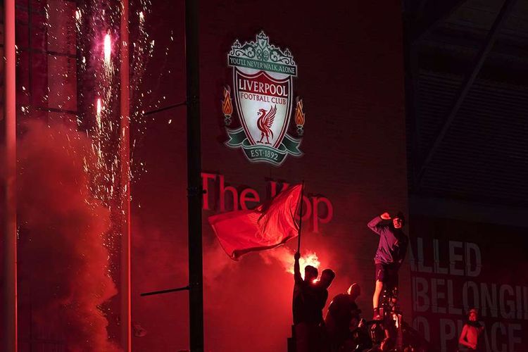 Liverpool fans celebrate in front of Anfield Stadium