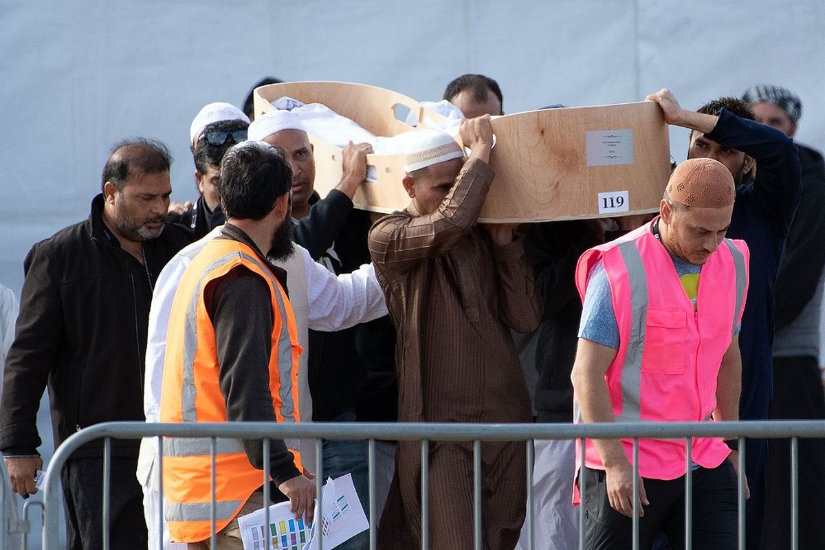 Para pelayat membuat sebuah peti berisi salah satu jenazah korban penembakan di masjid Christchurch, Selandia Baru, untuk dibawa ke Pemakaman Christchurch pada Jumat (22/3/2019).