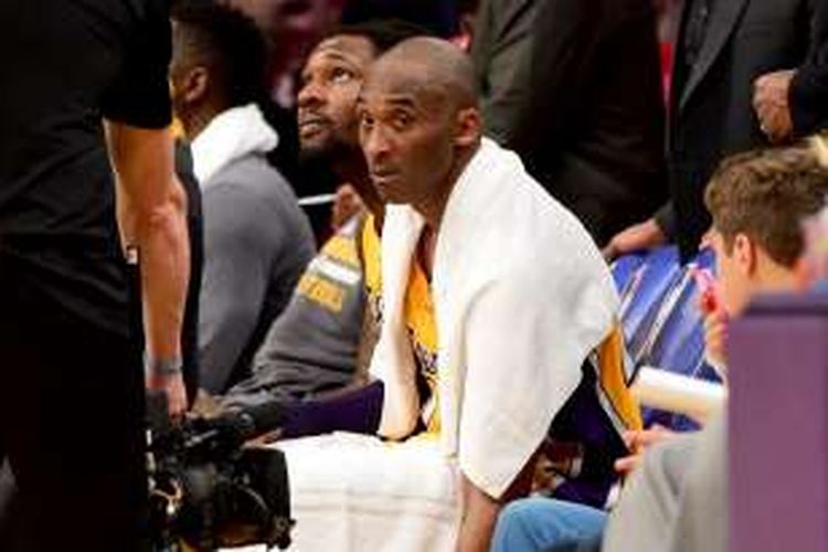 Pebasket Los Angeles Lakers, Kobe Bryant, duduk di bangku cadangan saat timnya bertemu Utah Jazz pada laga lanjutan NBA 2015-2016 di Staples Center, Rabu (13/4/2016).