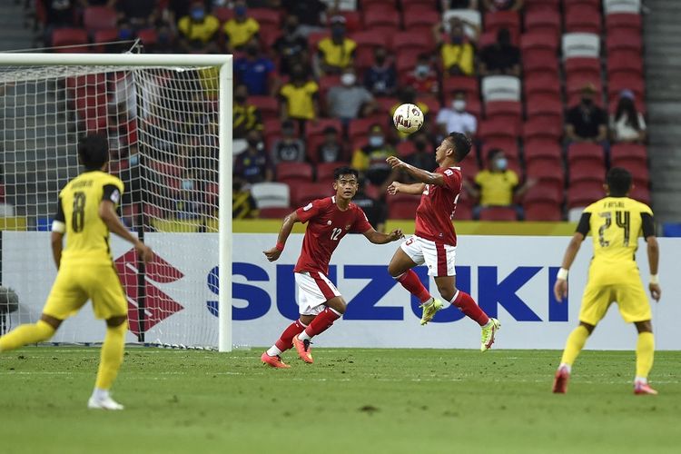 Indonesia vs Malaysia: pemain Indonesia Irfan Jaya (kedua dari kiri) menyundul bola saat melawan Malaysia pada pertandingan Grup B Piala AFF 2020 Indonesia vs Malaysia di Stadion Nasional Singapura pada 19 Desember 2021.