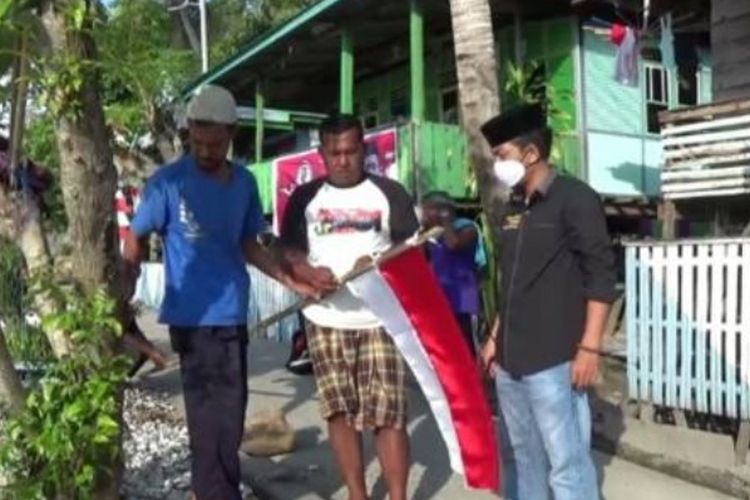 Seorang penyuluh agam di Polewali Mandar bagi-bagi bendera di pulau terpencil, Pulau Battoa.