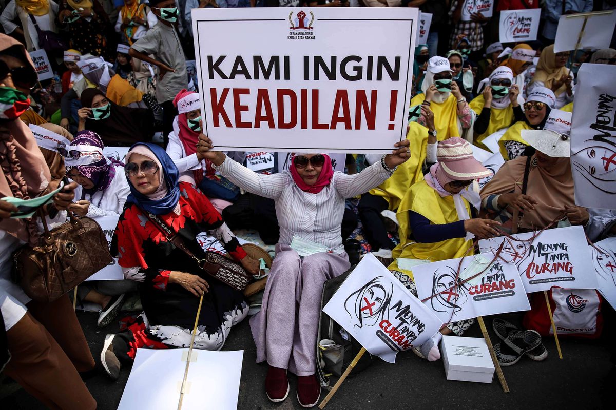 Massa pengunjuk rasa berkumpul di Jalan Medan Merdeka Barat sekitar Gedung Mahkamah Konstitusi, Jakarta Pusat, Selasa (18/6/2019). Mereka melakukan aksi unjuk rasa untuk mengawal sidang gugatan sengketa pemilihan presiden yang diajukan calon presiden dan calon wakil presiden nomor urut 02 Prabowo Subianto-Sandiaga Uno.