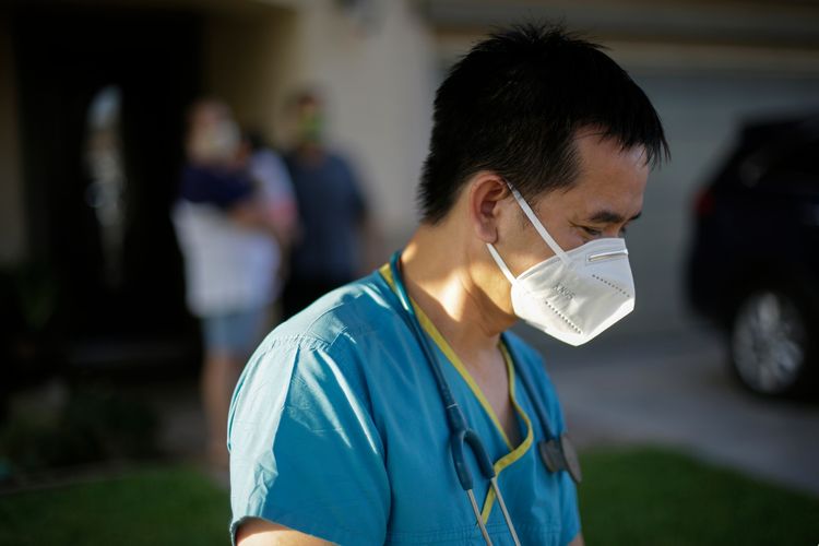 FILE - Dr. Tien Tan Vo leaves after talking with a family quarantining after they tested positive for the coronavirus July 23, 2020, in Calexico, California.