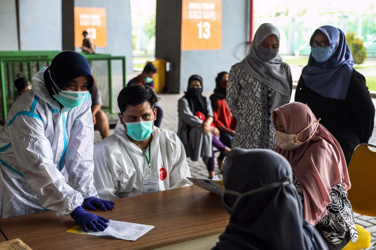 Tenaga kesehatan menggunakan alat pelindung diri (APD) menjelaskan proses pengambilan sampel darah di Stadion Patriot Chandrabhaga, Bekasi, Jawa Barat, Kamis (10/9/2020). Sebanyak 55 tempat tidur telah disiapkan pihak Pemerintah Kota Bekasi di stadion tersebut sebagai tempat untuk isolasi mandiri pasien Covid-19.