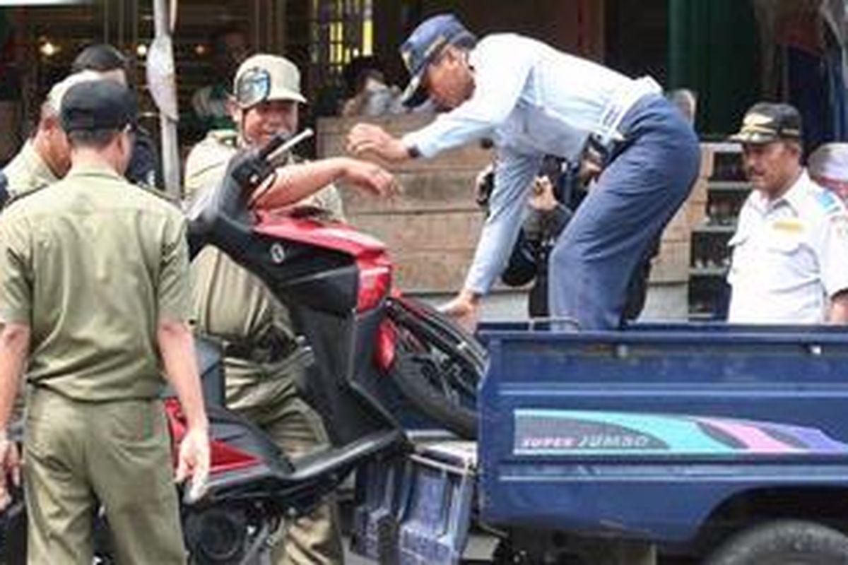 DIANGKUT - Sepeda Motor terpaksa diangkut petugas dalam Operasi Kawasan Tertib Lalu-Lintas (KTL) karena parkir sembarang tempat kemarin (14/07/2011).