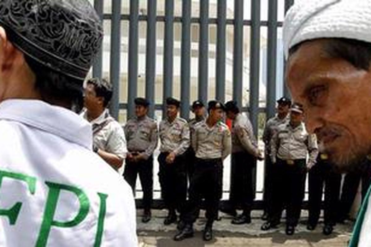 Polisi mengamankan unjuk rasa massa Front Pembela Islam (FPI) di depan Pusat Kebudayaan Belanda, Erasmus Huis, Jakarta Selatan, Selasa (28/9/2010). Pengunjuk rasa menuntut pusat kebudayaan membatalkan pemutaran film bertema gay dalam Q Film Festival yang akan menampilkan 150 film dari 20 negara yang mengangkat isu-isu tentang hak gay dan HIV/AIDS.