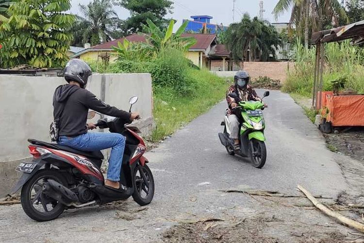 Dua orang pengendara sepeda motor terpaksa putar balik karena jalan ditutup dengan tembok batu bata di Kelurahan Penghentian Marpoyan, Kecamatan Marpoyan Damai, Kota Pekanbaru, Riau, Kamis (15/4/2021).