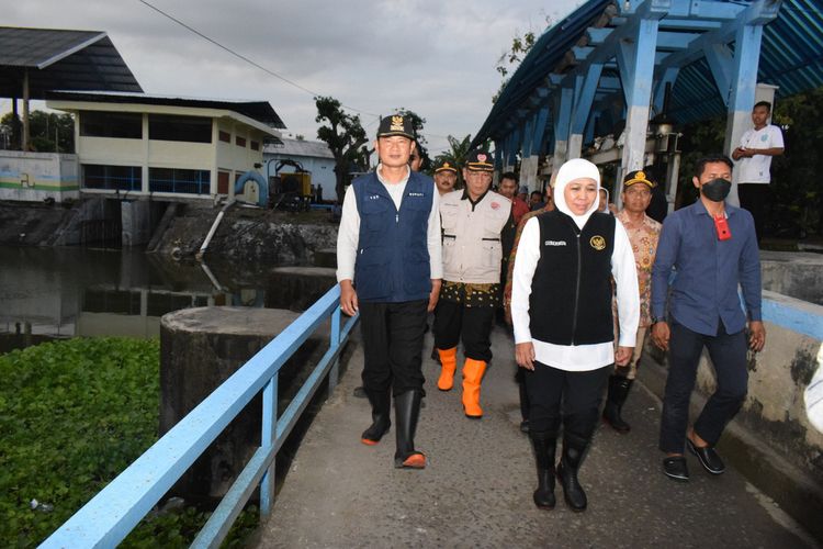Gubernur Jawa Timur Khofifah Indar Parawansa (depan) bersama Bupati Lamongan Yuhronur Efendi (kiri), saat meninjau pintu air Sluis Kuro, Jumat (24/2/2023).