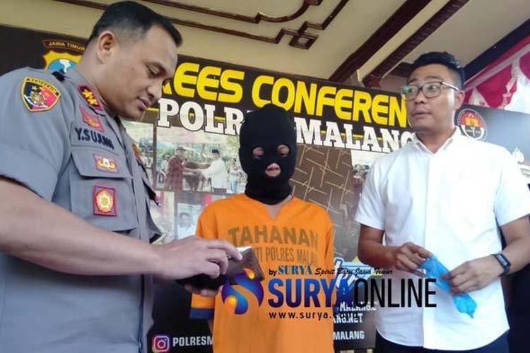 Kapolres Malang AKBP Yade Setiawan Ujung (kiri) didampingi Kasatreskrim Polres Malang, AKP Adrian Wimbarda, ketika menanyai tersangka pasutri yang sediakan layanan seksual menyimpang dengan tarif Rp 3 juta, Senin (24/6/2019). 

