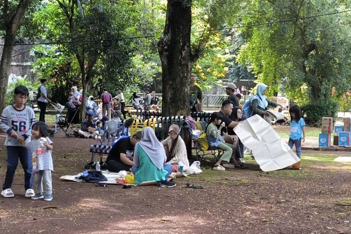 Pengunjung yang tengah piknik di Taman Margasatwa Ragunan pada hari kedua libur lebaran 2025.