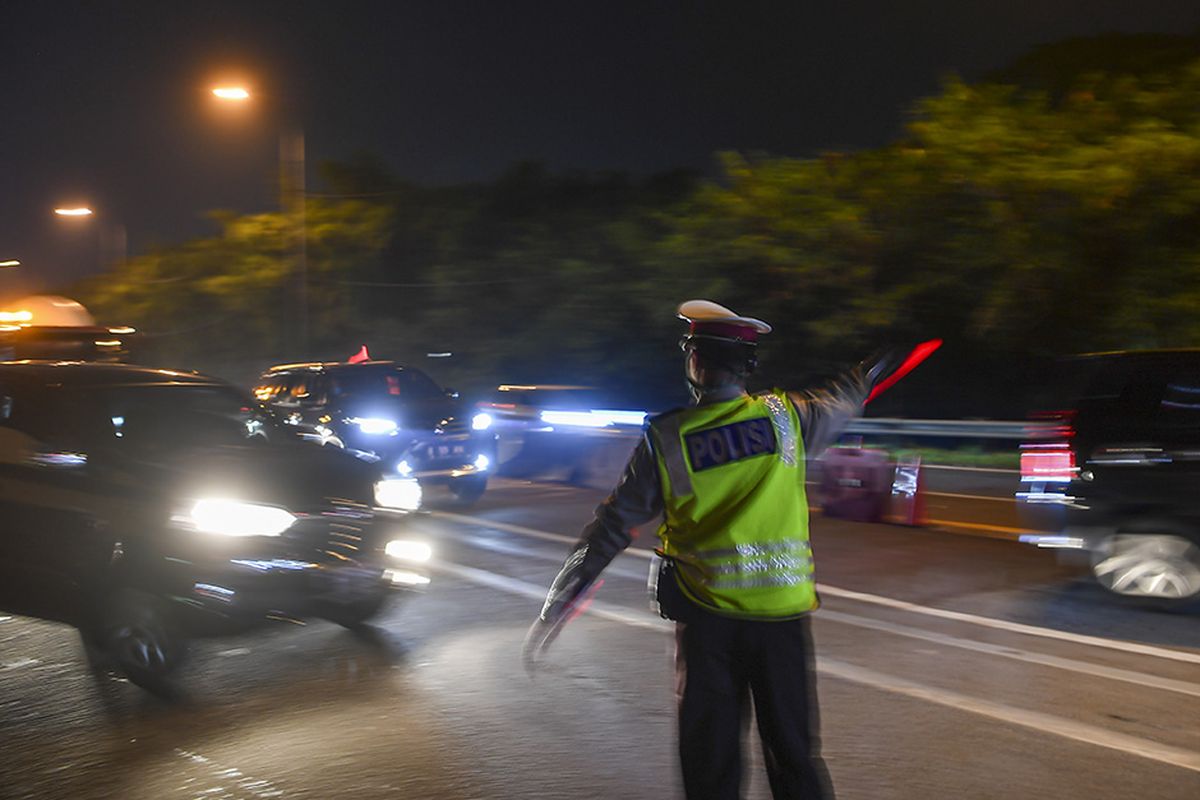 Petugas kepolisian mengarahkan kendaraan pribadi yang melintas di tol Jakarta-Cikampek untuk keluar melalui pintu tol Cikarang Barat 3, Jawa Barat, Kamis (21/5/2020). Pengalihan tersebut sebagai upaya penyekatan gelombang pemudik jelang perayaan Hari Raya Idul Fitri 1441 H dari arah Jakarta menuju Jawa Tengah.