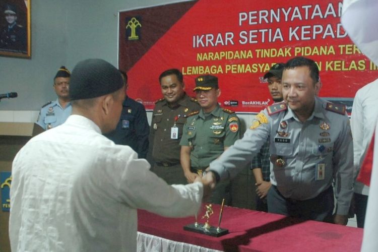 Kepala Lapas Tegal, Yugo Indra Wicaksi menjabat tangan Narapidana terorisme (napiter) Darwis (48) usai pembacaan pernyataan ikrar setia kepada NKRI di dalam Lapas Kelas IIB Tegal, Jawa Tengah, Selasa (11/7/2023).