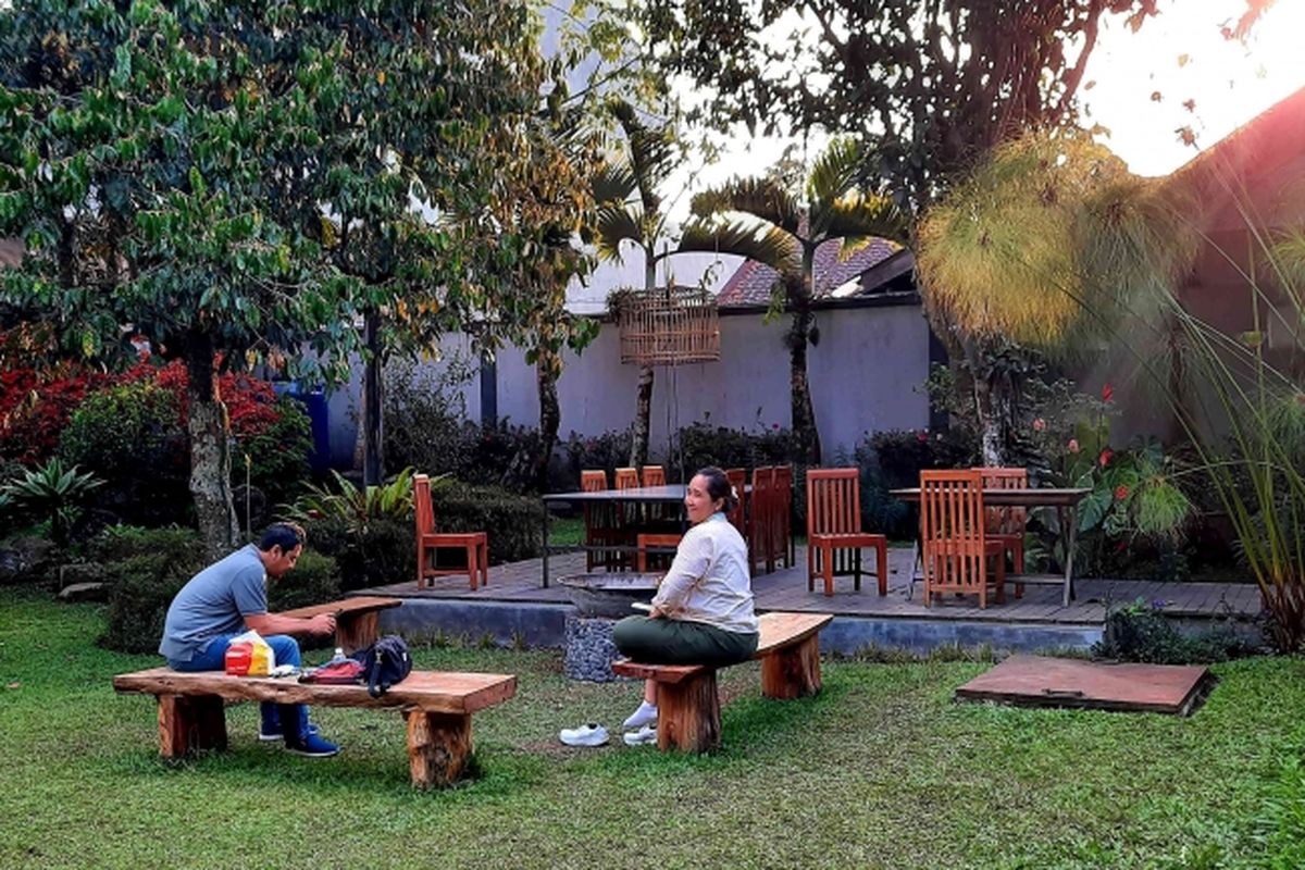 Memilih akomodasi yang menyediakan taman dan area makan outdoor.