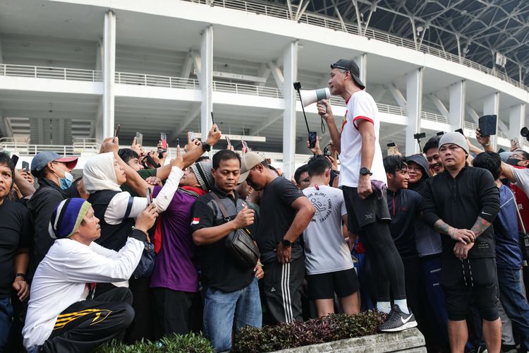 Gubernur Jawa Tengah sekaligus bakal calon presiden yang diusung Partai Demokrasi Indonesia Perjuangan, Ganjar Pranowo menyapa simpatisan saat lari pagi di kawasan Stadion Gelora Bung Karno, Jakarta, Minggu (30/4/2023).