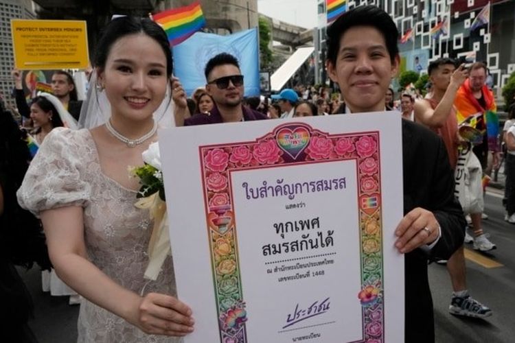 Peserta Parade Kebanggaan (Pride) memegang poster untuk merayakan kesetaraan dalam pernikahan di Bangkok, Thailand, 1 Juni 2024. 