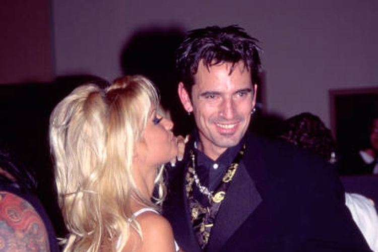 View of married couple, actor & model Pamela Anderson and Rock musician Tommy Lee (born Thomas Lee Bass), as they attend Atlantic Records' post-Grammy party at the Parkinson Building (formerly Bullocks department store), Los Angeles, California, March 1, 1995. The couple had been married less than two weeks earlier. (Photo by Gary Gershoff/Getty Images)