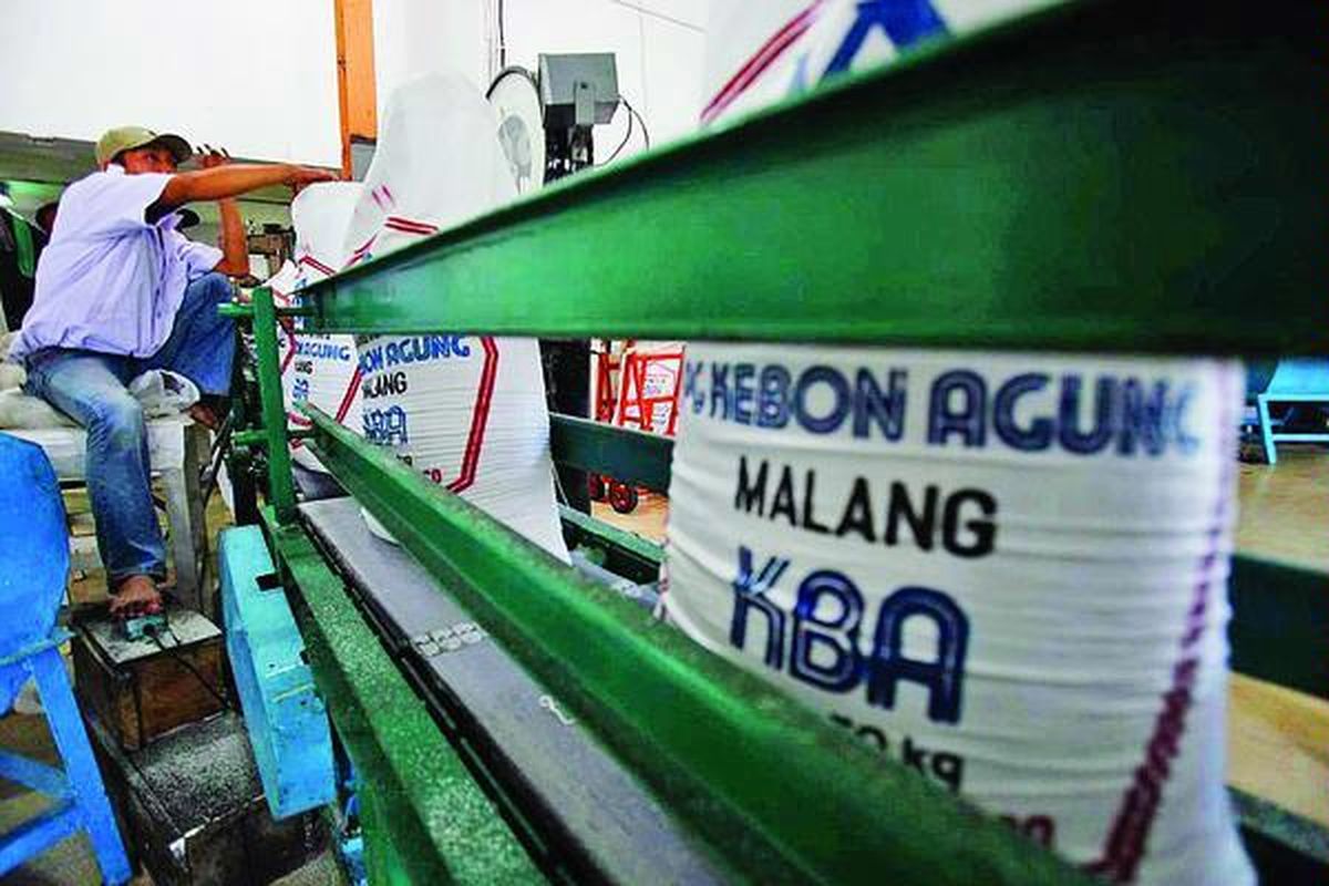 Pekerja  mengepak gula kristal di Pabrik Gula Kebon Agung, Kabupaten Malang, Jawa Timur, Jumat (10/6).