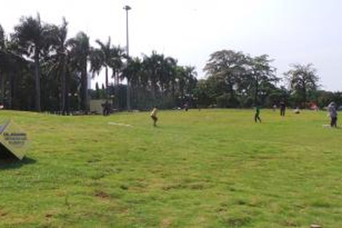 Pengunjung dan PKL di lebaran kedua di Monas, Jakarta Pusat, banyak yang menginjak rumput. Selasa (29/7/2014).