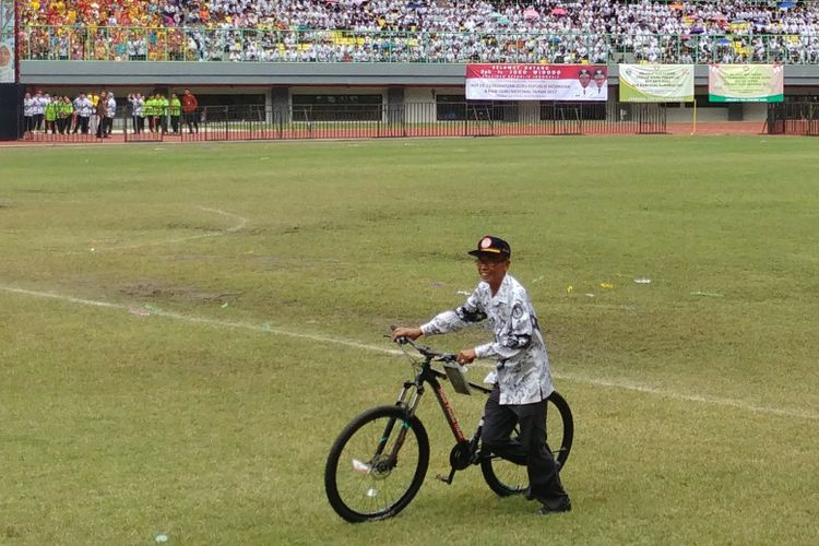 Rahmat, guru asal Tasikmalaya mendapatkan hadiah sepeda dari Presiden Jokowi dalam peringatan HUT RI ke-72 dan Hari Guru Nasional 2017 di Stadion Patriot Candrabhaga, Bekasi (2/11/2017).