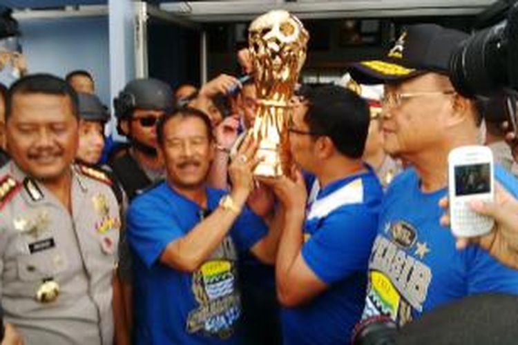 Wali Kota Bandung Ridwan Kamil dan Manager Persib Umuh Muchtar (kiri) saat sama - sama mengangkat piala usai Persib Bandung menjadi juara ISL 2014. Ini dilakukan saat pertama tiba di Bandara Husein Sastranegara, Bandung, Sabtu, (8/11/2014). Pada saat itu juga, Emil dan Umuh mulai membotakin kepalanya, sisanya dilanjutkan besok.
