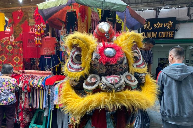 Barongsai menjadi salah satu hiburan yang ada di Pasar Petak Sembilan, Pecinan, Glodok, Jakarta Barat pada Rabu (18/1/2023). Pemain barongsai tampak memberikan amplop kepada pembeli untuk diisi dengan uang.  