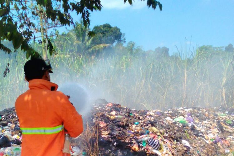 Petugas Damkar tengah melakukan pembasahan lokasi kebakaran di lahan perkebunan tebu di Dusun Krajan, Kelurahan Beji, Ungaran Timur, Rabu (26/7/2017) siang.