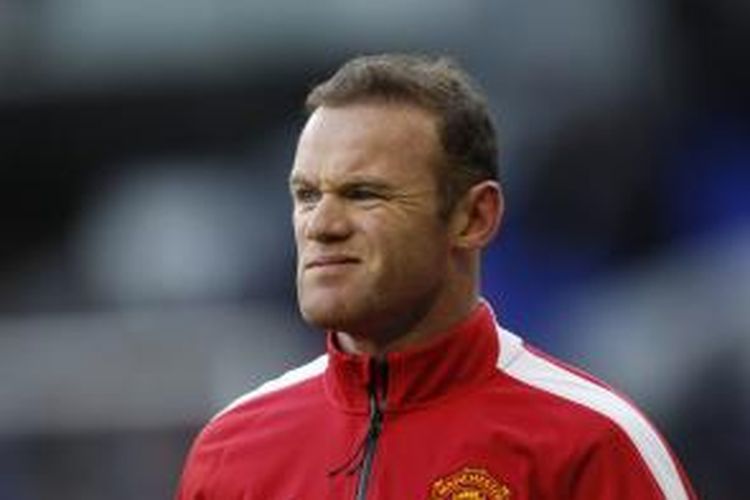 Salah satu ekspresi penyerang Manchester United Wayne Rooney dalam sesi pemanasan sebelum pertandingan Premier League melawan Tottenham Hotspur, di White Hart Lane, London, Minggu (28/12/2014).