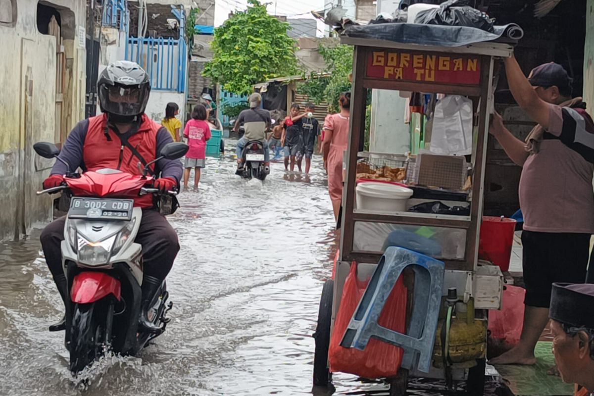 Kampung Rawa Bamban, Kelurahan Jurumudi Baru, Kecamatan Benda, Kota Tangerang masih terendam banjir hingga sore ini pukul 18.00 WIB, Jumat (24/2/2023).  Banjir itu terjadi akibat hujan yang mengguyur Kota Tangerang sejak Kamis (23/2/2023) malam.