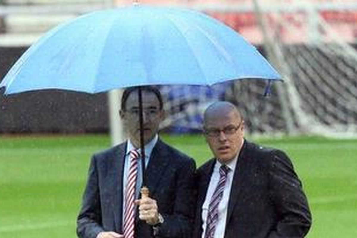 Pelatih Sunderland dari Irlandia Utara, Martin ONeil (kiri), dan Pelatih Reading asal Inggris, Brian McDermott (kanan), sedang menginspeksi lapangan Stadium of Lights, Sabtu (25/8/2012). Laga kedua tim akhirnya ditunda karena lapangan yang tergenang air dan ramalan cuaca yang menyatakan hujan tak akab berhenti pada sore itu. 