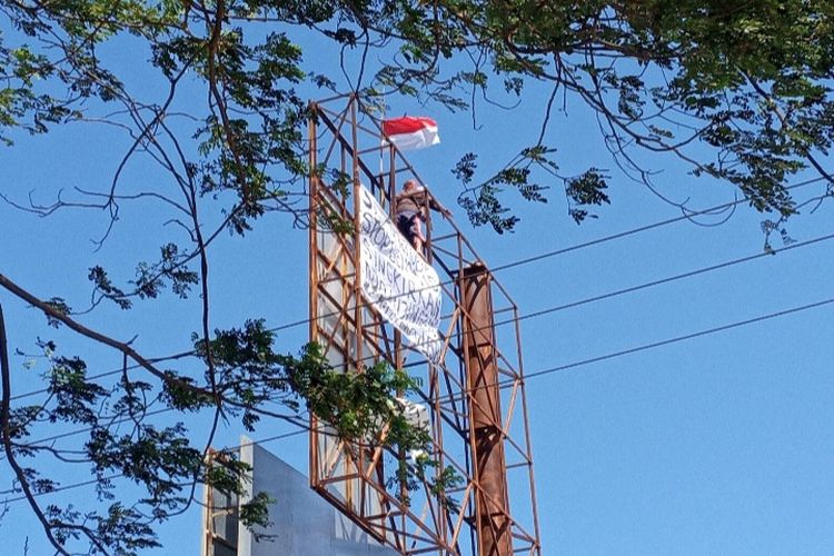 Foto: Pria yang diketahui bernama Agus nekat naik papan reklame setinggi belasan di Gelora Samador, Kelurahan Kabor, Kecamatan Alok, Sikka, Jumat (2/9/2022).