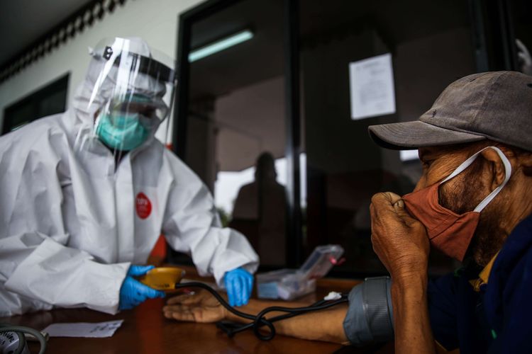 Petugas kesehatan memeriksa tunawisma di GOR Ciracas, Jakarta Timur,  Jumat (1/5/2020). Penyandang masalah kesejahteraan sosial (PMKS) yang ditampung terdiri dari pengemis, pemulung, pengamen, juru parkir liar, orang terlantar, ODMK (orang dengan masalah kejiwaan), dan lainnya.