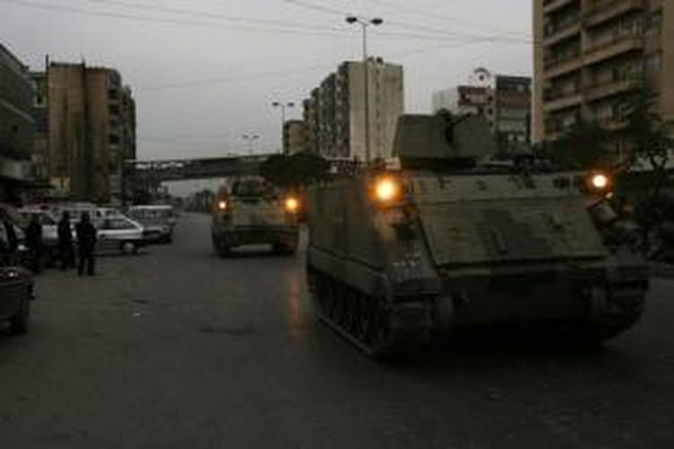 Kendaraan lapis baja angkatan darat Lebanon berpatroli di jalanan kota pesisir Tripoli, Senin (2/12/2013). Pemerintah Lebanon memutuskan mengirim militer untuk memerintah kota itu selama enam bulan ke depan setelah terjadi kekerasan sektarian yang menewaskan 10 orang.