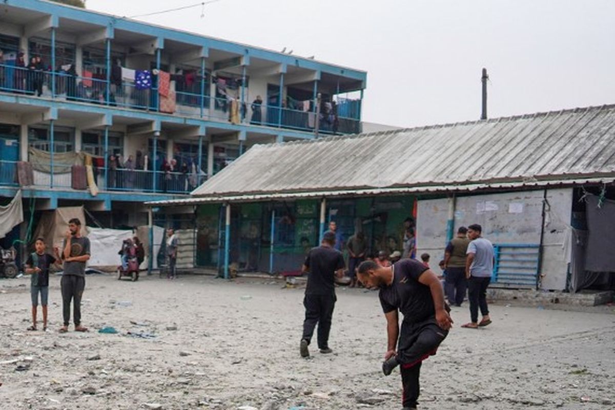 Anak laki-laki Palestina berdiri di kompleks sekolah PBB yang menampung pengungsi yang terkena pengeboman Israel di Nuseirat, di Jalur Gaza tengah, pada Kamis (6/6/2024), di tengah konflik yang sedang berlangsung antara Israel dan kelompok militan Hamas Palestina. Militer Israel mengatakan pada tanggal 6 Juni bahwa jet tempurnya telah menyerang sebuah sekolah milik PBB yang digunakan oleh militan Palestina di Gaza tengah, dan pihak berwenang di wilayah yang dikelola Hamas melaporkan sedikitnya 27 orang tewas. 