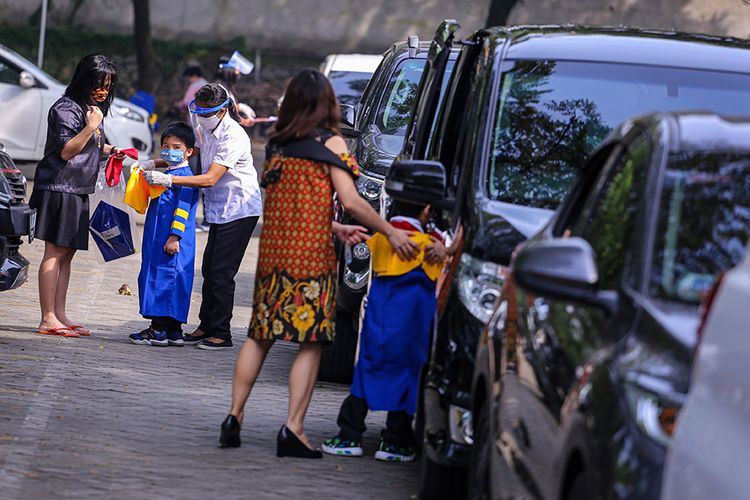 Siswa sekolah Stella Maris bersiap sebelum mengikuti acara kelulusan secara drive thru di Stella Maris School, Kelapa Dua, Kabupaten Tangerang, Banten, Selasa (9/6/2020). Kegiatan wisuda tersebut digelar secara drive thru guna menghindari kerumunan yang bisa menjadi medium penyebaran COVID-19.